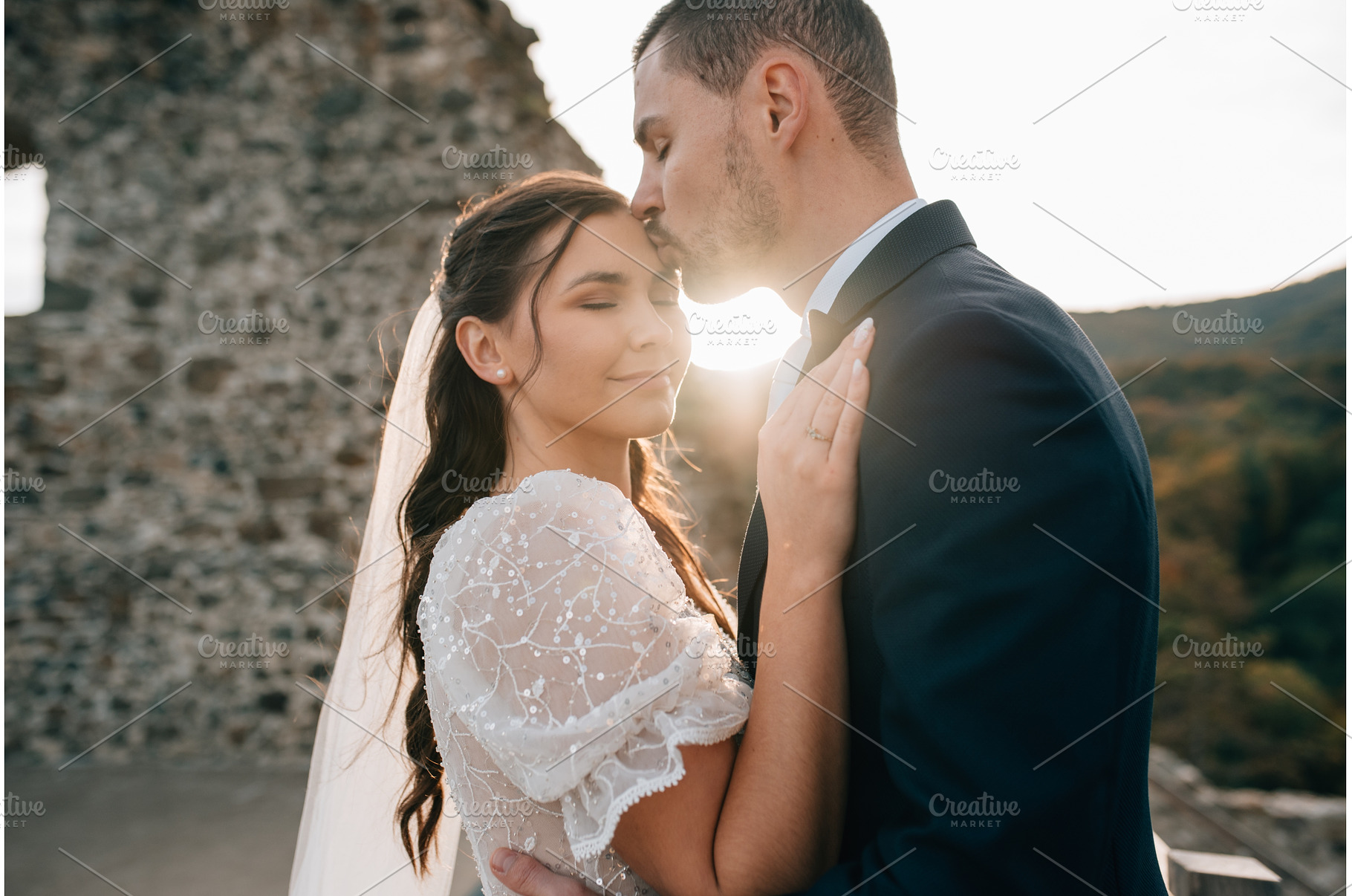 Groom kissing bride on her forehead., a Person Photo by HalfPoint