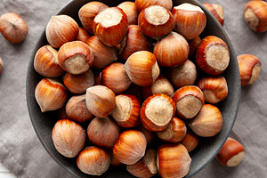Organic Raw Hazelnuts in a Bowl, top view. Close-up., a Food & Drink Photo by LiudmylaChuhunova