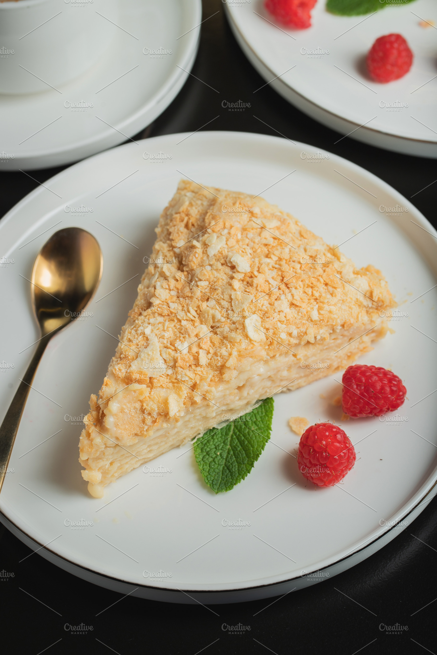 Sliced Napoleon cake on a white wooden table. Classic dessert, a Food & Drink Photo by Budarinphoto
