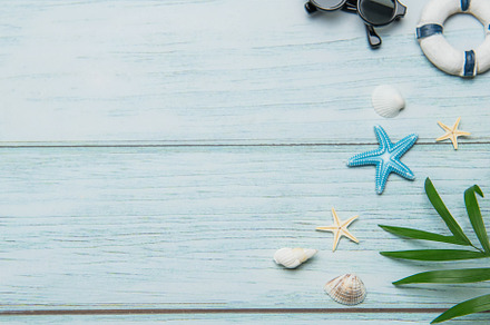Planning summer vacation with airplane, flip flops and seashells