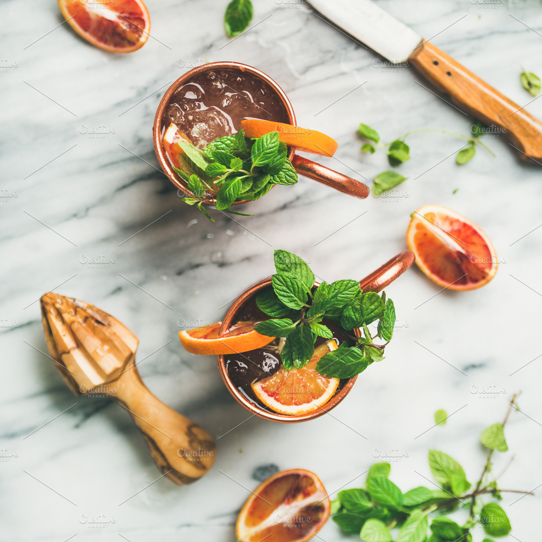 Blood orange Moscow mule alcohol cocktails, marble background, square crop, a Food & Drink Photo by Foxys
