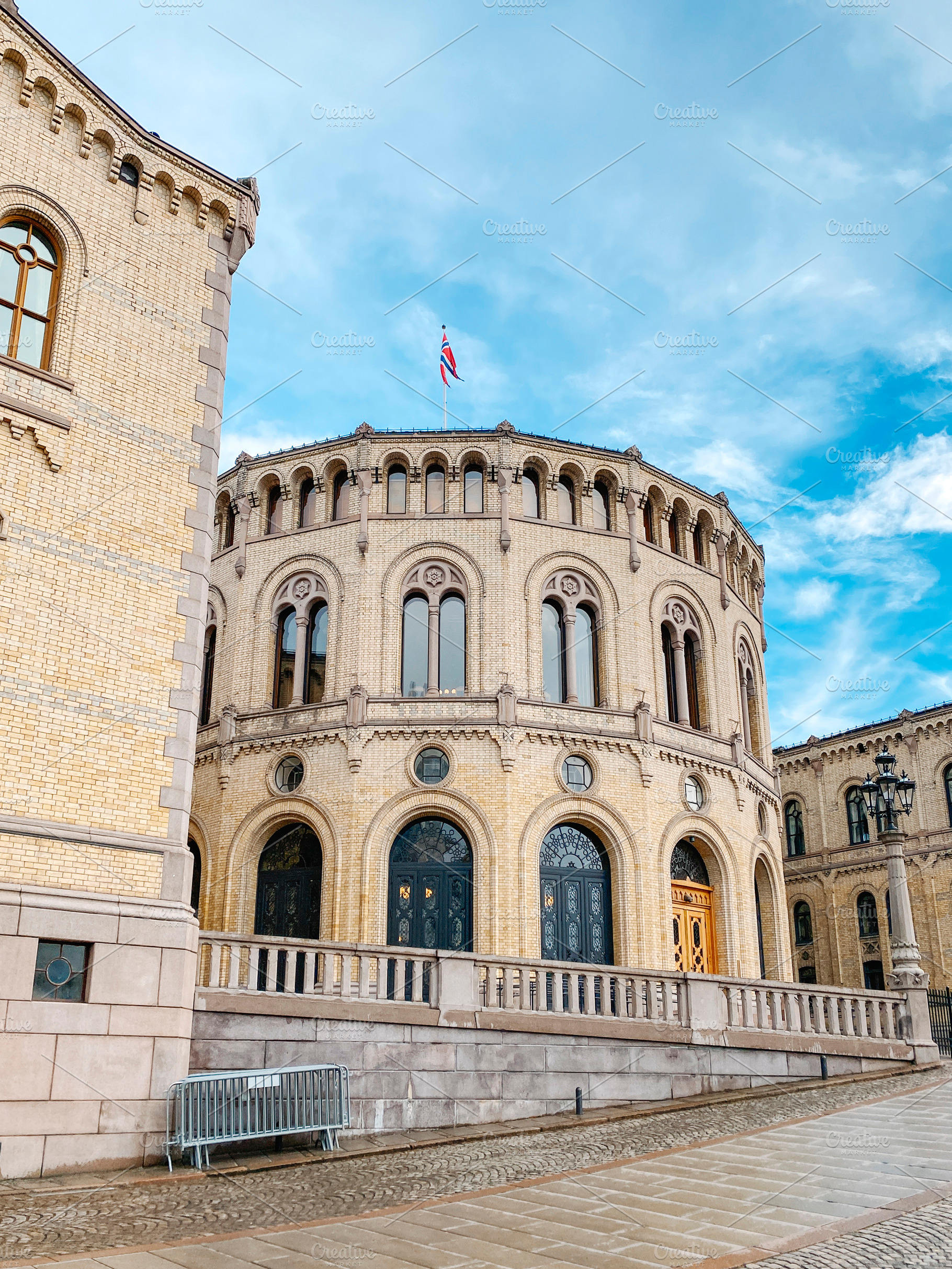 curved facade of the Norwegian Parliament in Oslo, a Photo by Nito
