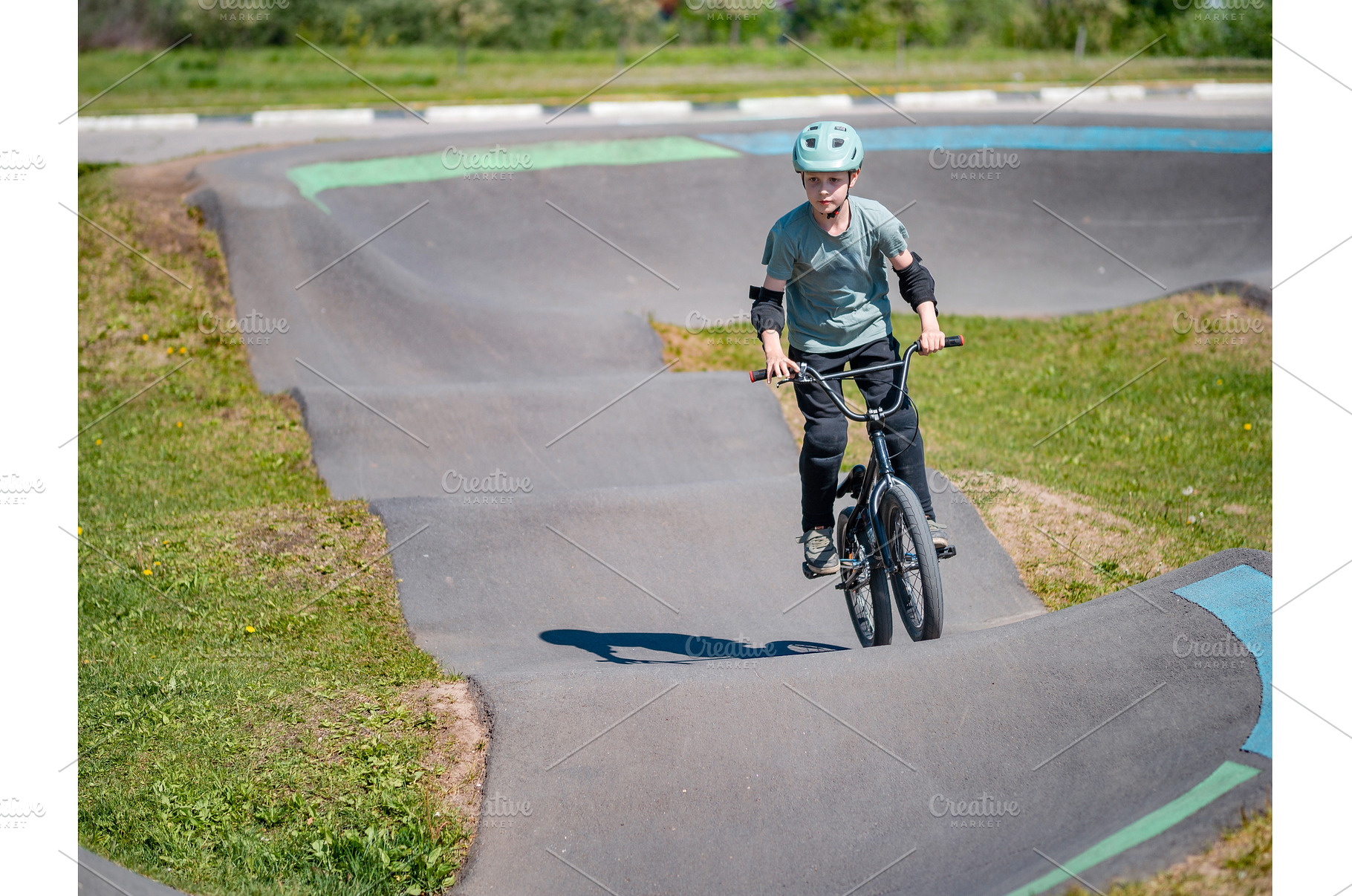 Pump track. Child on bmx bike rides, a Sports & Recreation Photo by Fascinadora