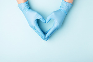 Hand in medical gloves.