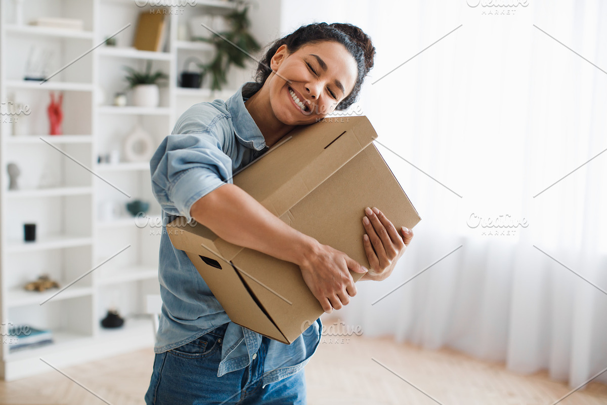 Joyful Customer Woman Holding Cardboard Box And Hugging It Indoors, a Photo by Prostock-Studio (Photo 2 of 4)