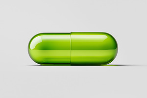 Green capsule pill lying on a light, a Health & Medical Photo by MistyDay