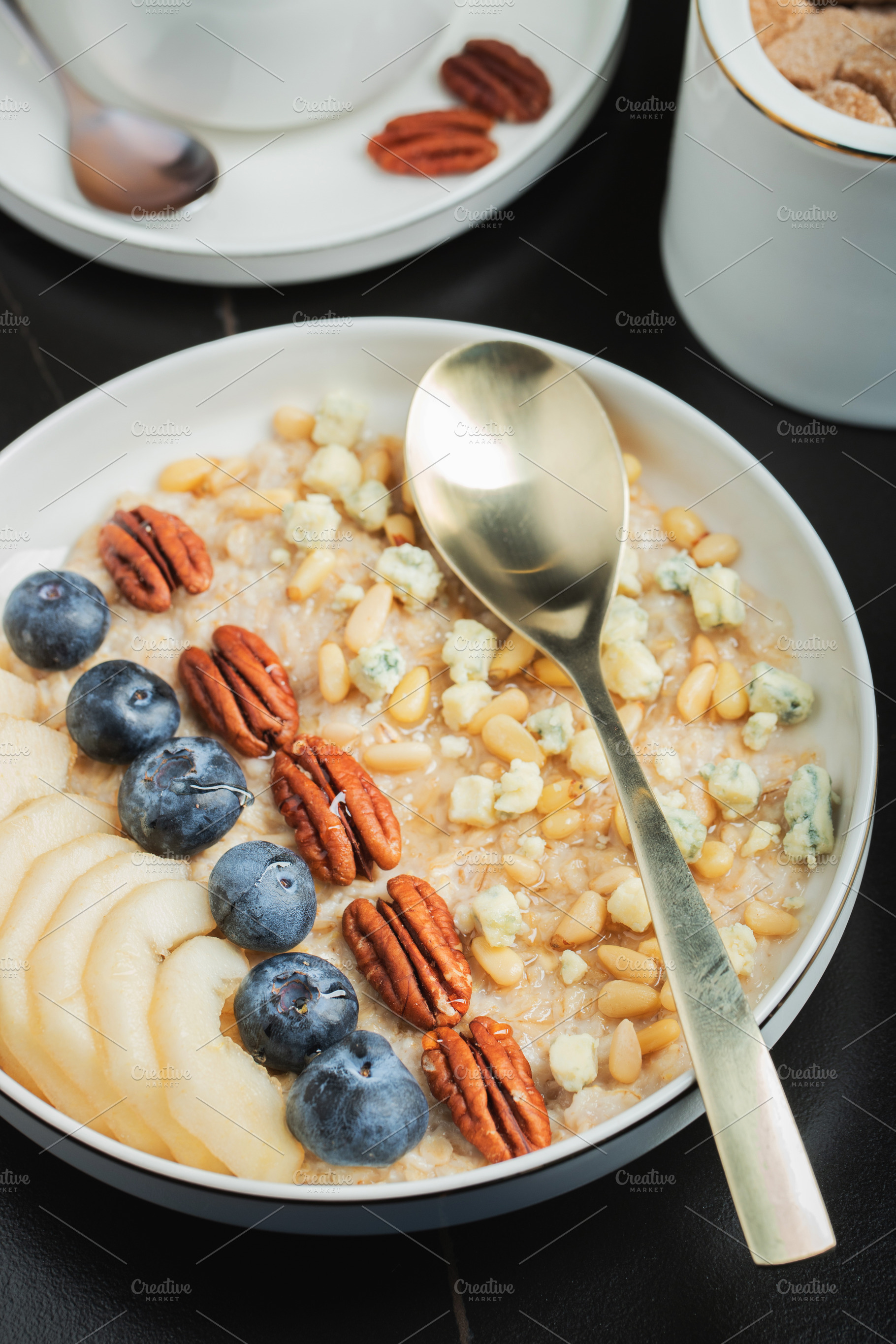 Oatmeal. Bowl of oatmeal porridge with blackberry, bananas and chia seeds on gr, a Food & Drink Photo by Budarinphoto
