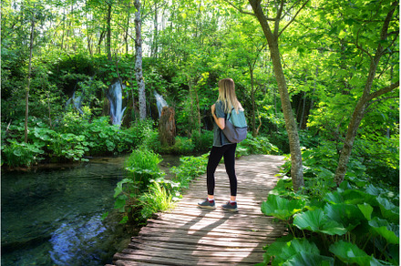 Young woman with backpack on wooden, a Person Photo by den-belitsky