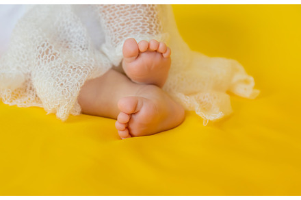 Baby feet on a yellow background, a Person Photo by yanadjana