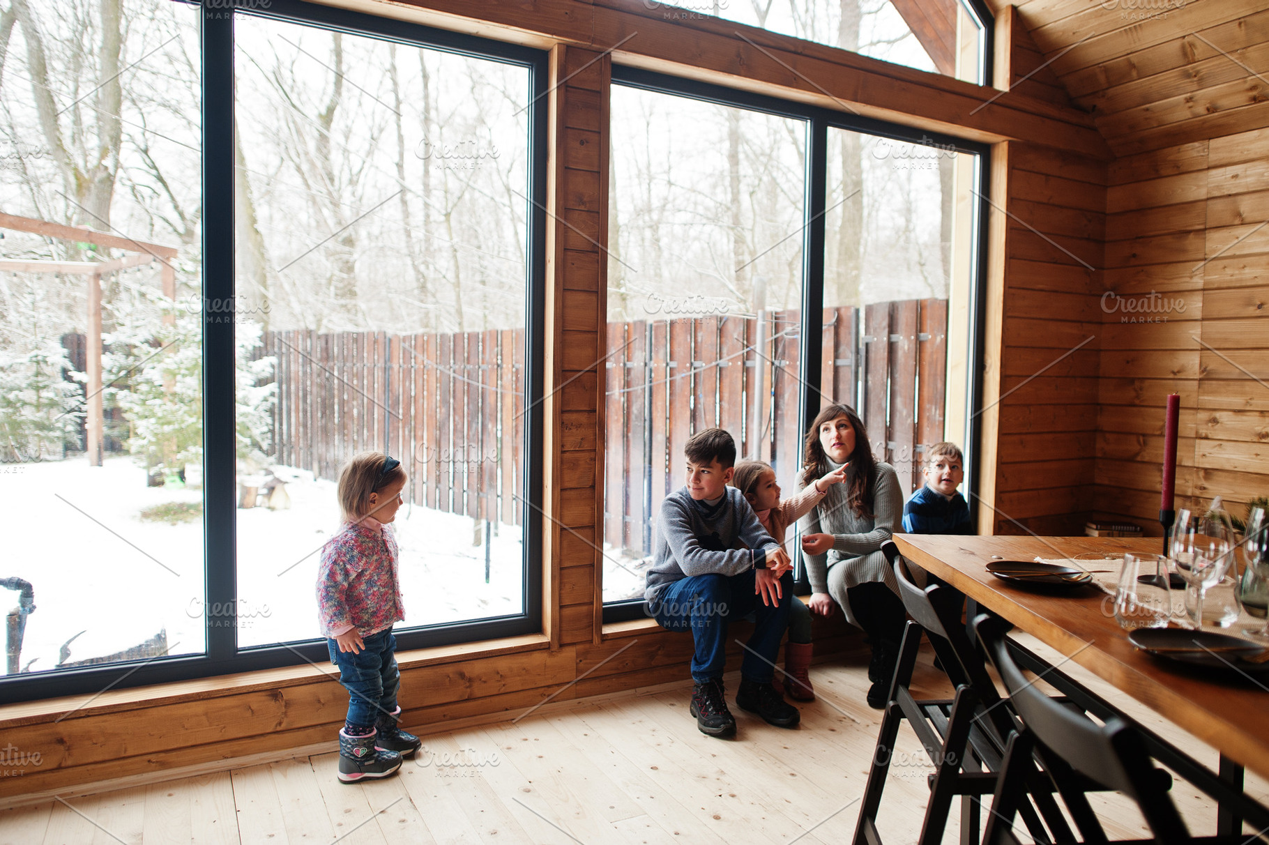 Mother and kids in modern wooden house with table, spending time, a Person Photo by AS photostudio