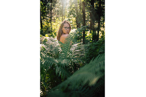 Woman in Sunlit Forest Surrounded by, a Person Photo by Jan Jack Russo Media