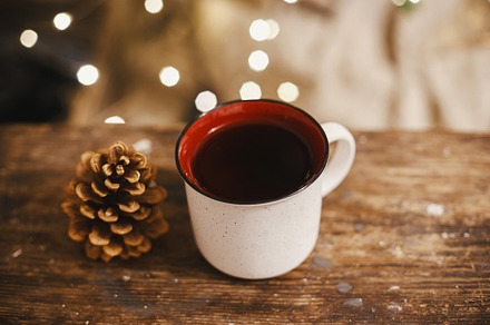 Stylish cup and pine cone on rustic wood on background of christ, a Holiday Photo by Sonjachni