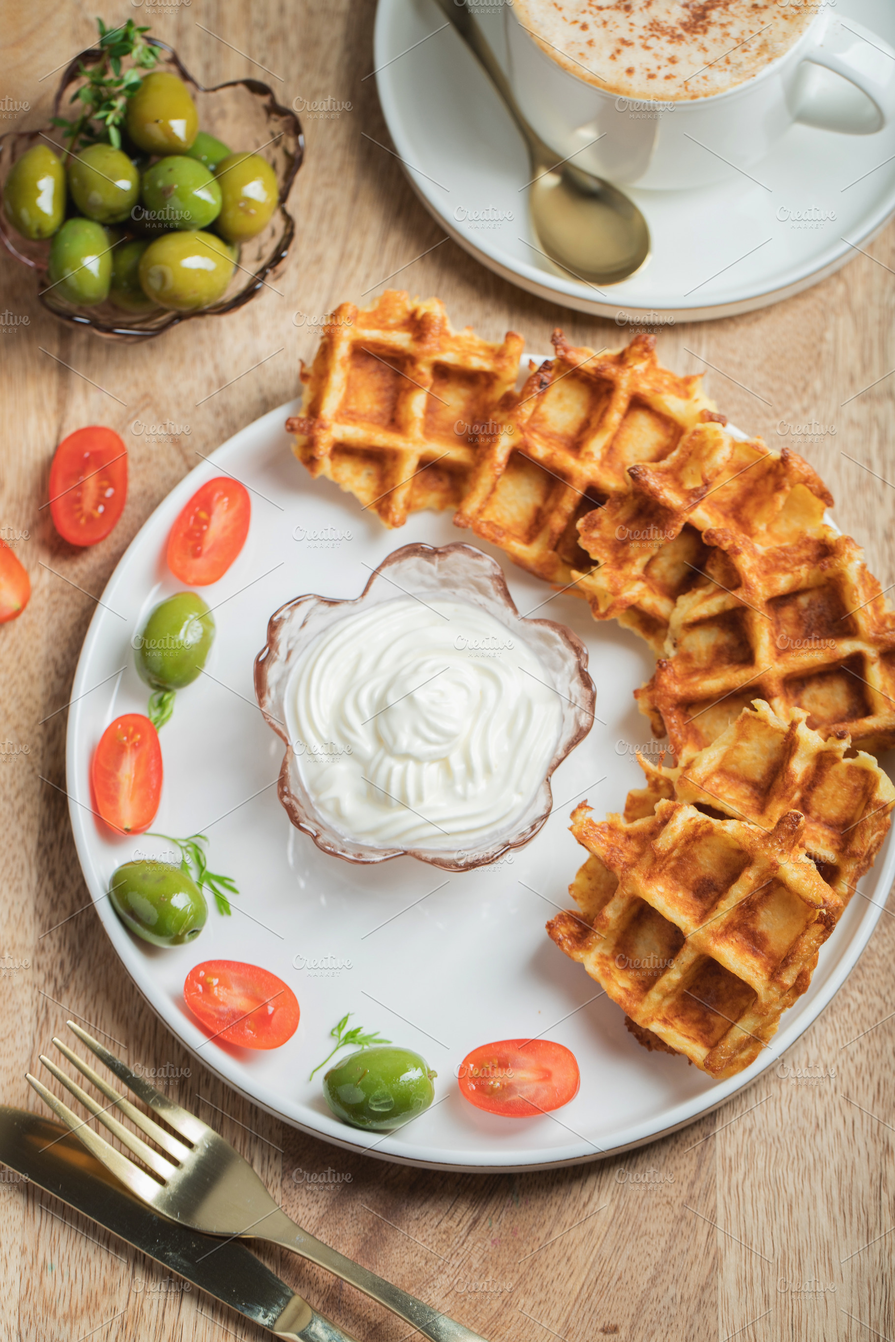 Top view of Homemade Potato Waffles, ricotta cheese and mayonese sauce. Served, a Food & Drink Photo by Budarinphoto