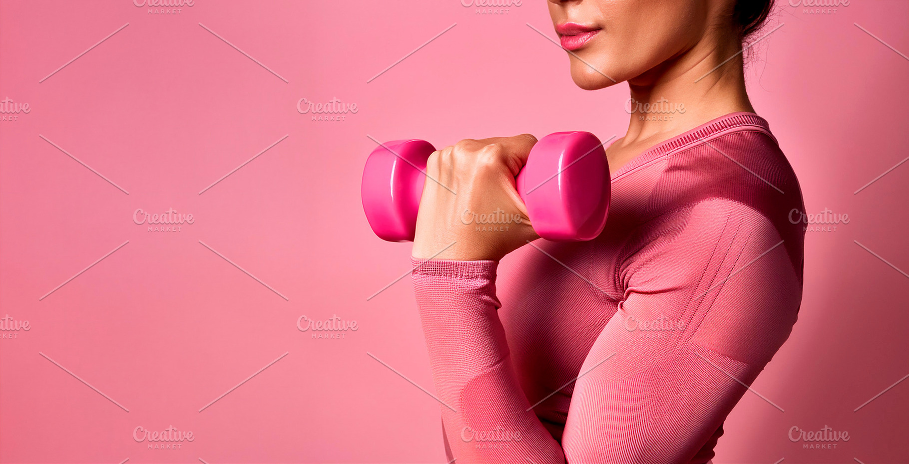 Half body sporty woman lifting a dumbbell with pink background, a Sports & Recreation Photo by Davizro's Market