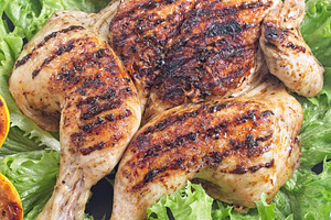 Grilled spatchcocked chicken with lemon garlic marinade on lettuce with lemon h, a Food & Drink Photo by iuliia_n