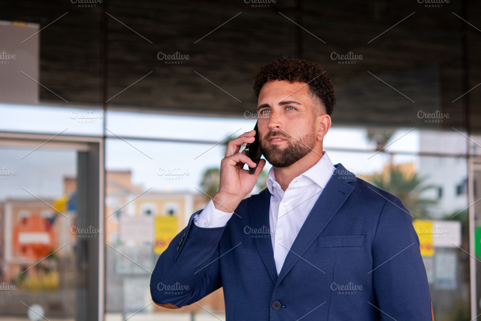 Businessman talking on smartphone outside office, a Business Photo by etorres69