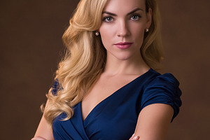 Confident blonde woman in blue dress with arms crossed, portrayi, a Person Photo by Studio ANNA