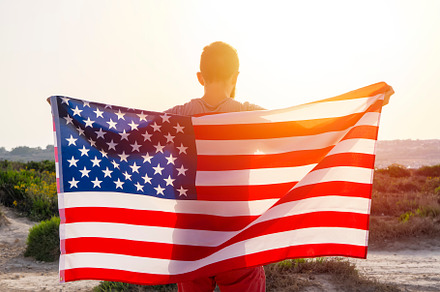 Rear view of man holding USA flag