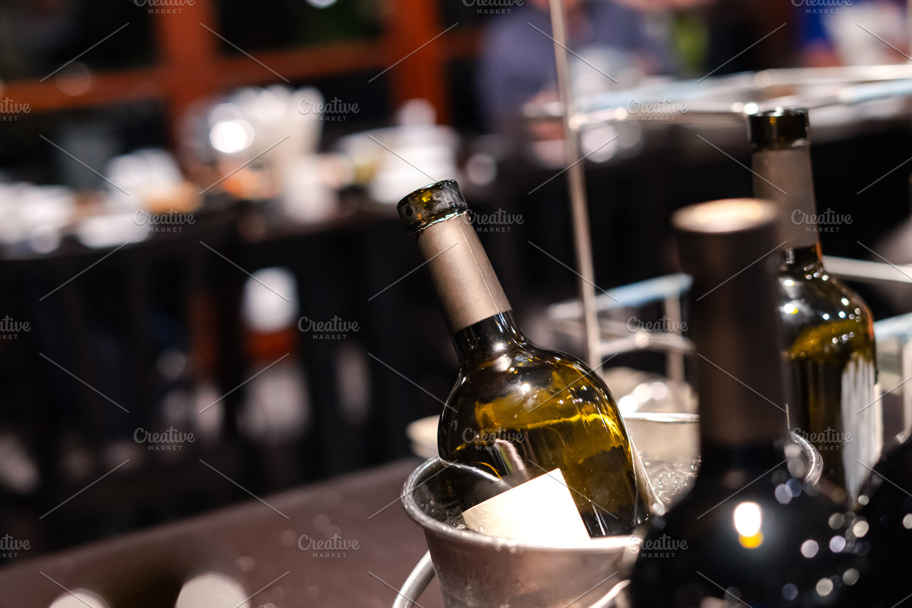 close-up of red wine bottle in ice bucket on romantic table, bac, a Food & Drink Photo by Casanowe-studio