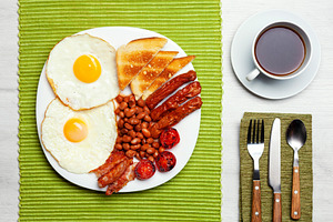 Full English breakfast with fried eggs, sausages, bacon, beans, toast and a cup, a Food & Drink Photo by Antonio Gravante Market