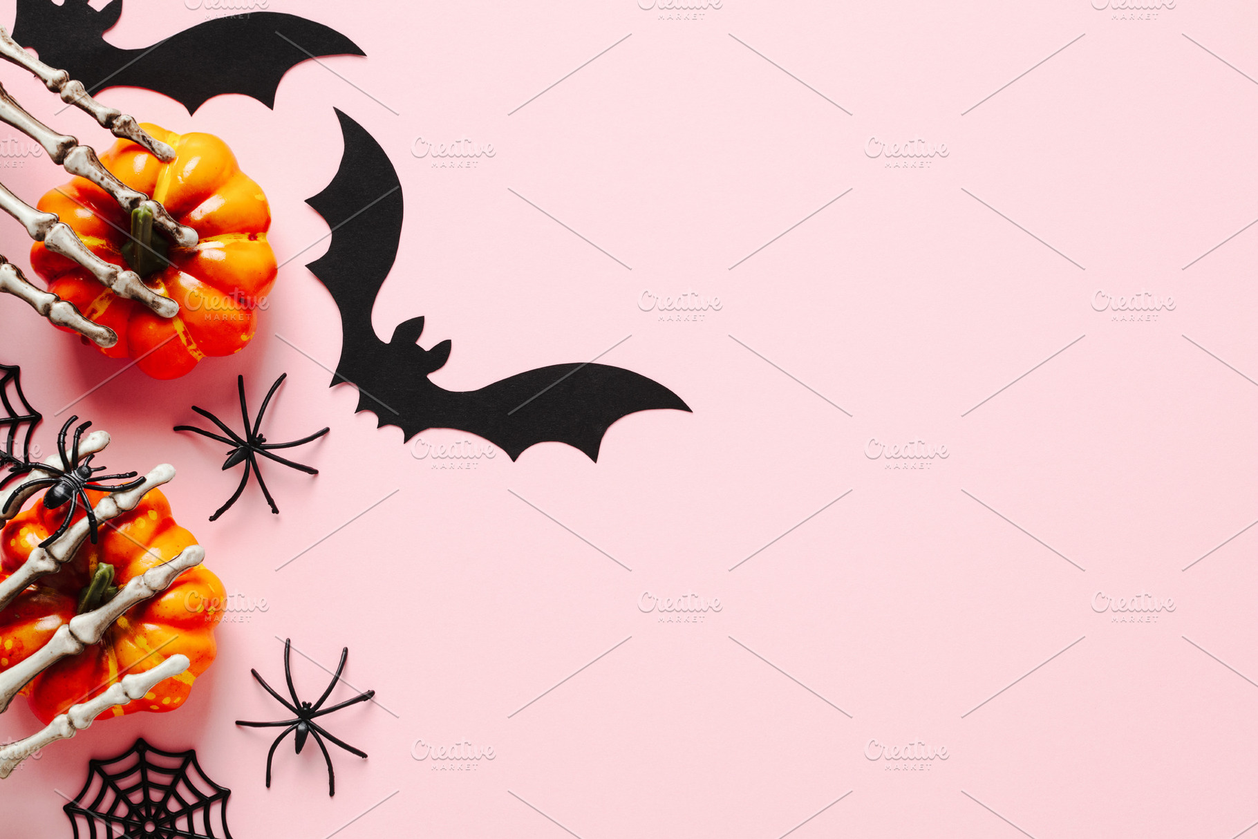 Halloween flat lay composition with orange pumpkins, spiders, bats on pastel pi, a Holiday Photo by photoguns