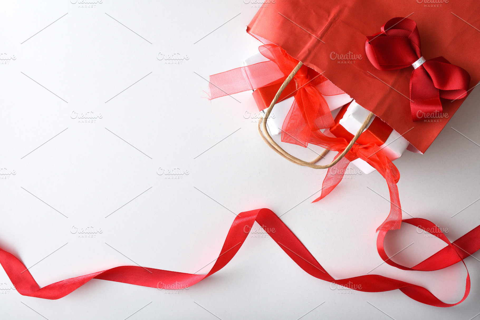 Gift concept with red shopping bag with gifts and ribbon, a Holiday Photo by Davizro's Market