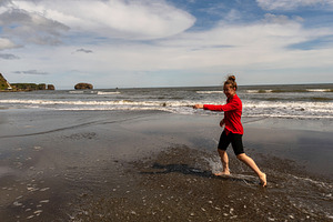Girl running along shoreline, a Person Photo by Elena Vagengeim