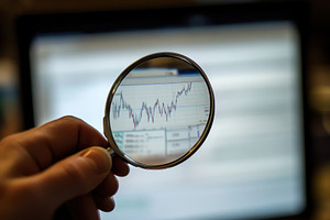 Analyzing stock market trends throug, a Photo by Tanuart