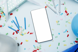 Concept of celebration and technology. Smartphone with blank screen surrounded, a Photo by matucha