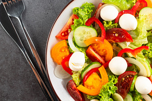 salad with red and yellow tomatoes, peper, cucumbers, lettuce an, a Food & Drink Photo by vimart