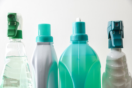 Detail of the top of four plastic cleaning bottles isolated, a Health & Medical Photo by Davizro's Market