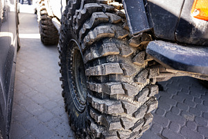 Close-up of rugged off-road tire with detailed tread design, a Photo by AS photostudio