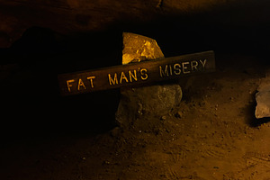 Fat Man's Misery sign in Mammoth Cave interior, Kentucky USA, a haunting underg, a Nature Photo by AS photostudio