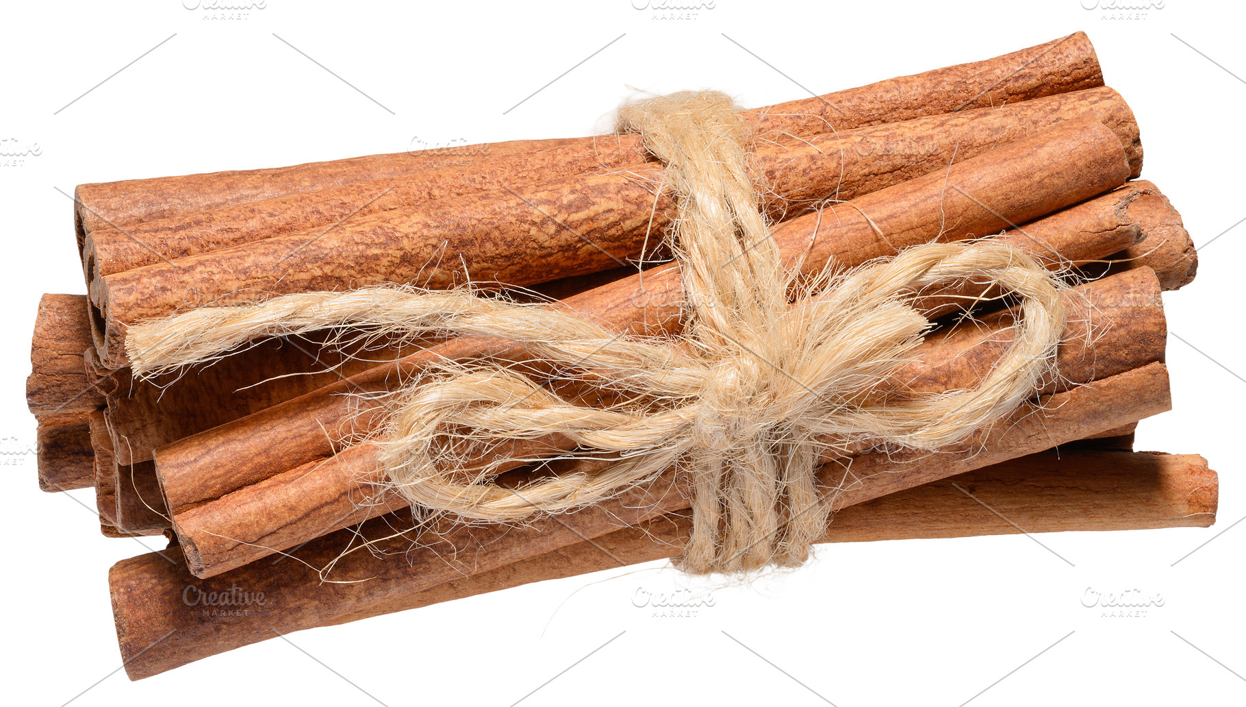 Dry cinnamon sticks tied with twine on isolated background, a Food & Drink Photo by ndanko