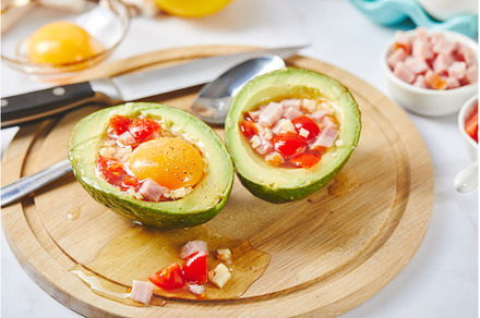 Avocado with egg, ham, tomatoes and