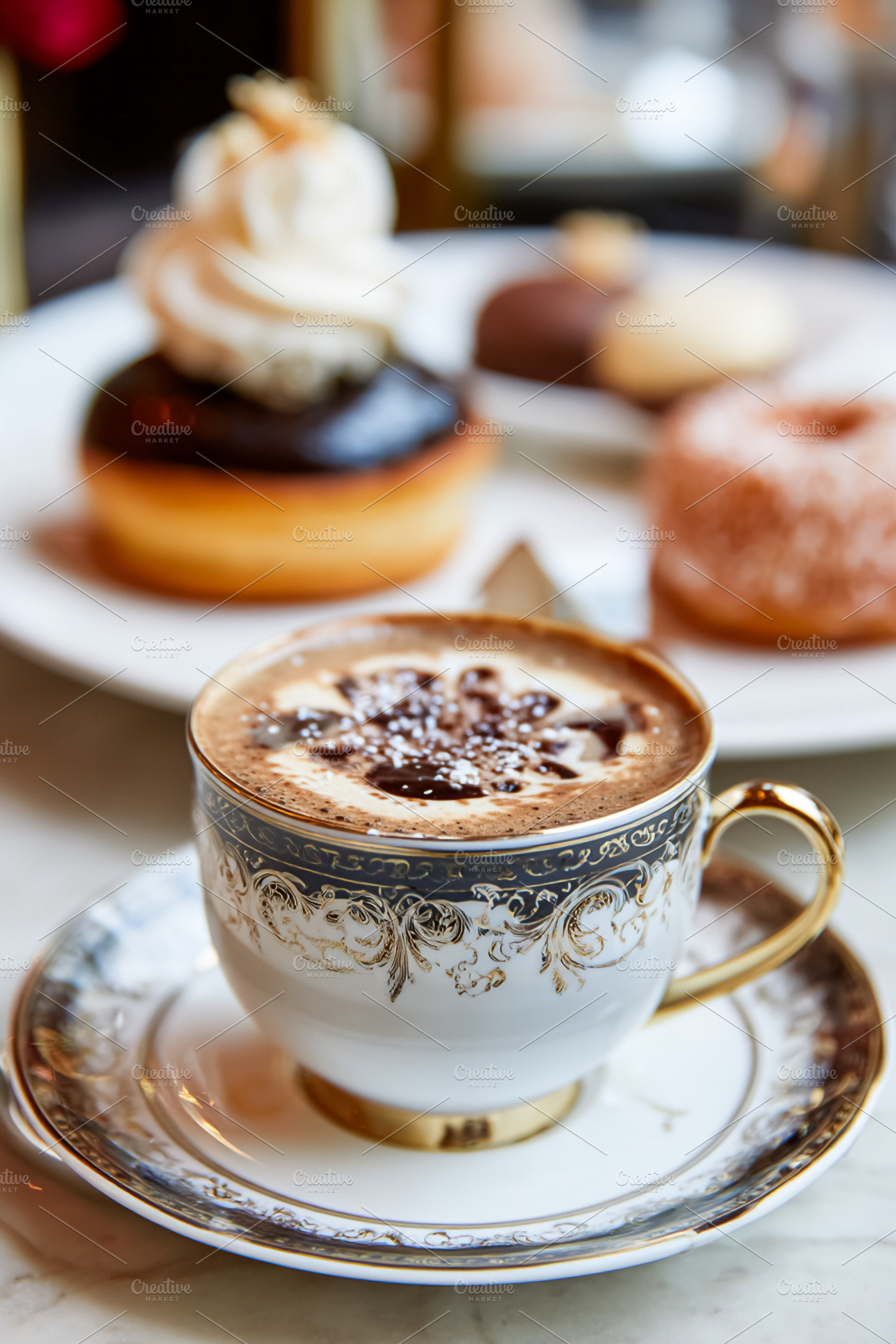 Coffee drink with foam and chocolate art in a fancy porcelain cu, a Photo by Studio ANNA