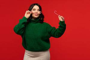Woman in green sweater playfully, a Holiday Photo by Elena Vagengeim