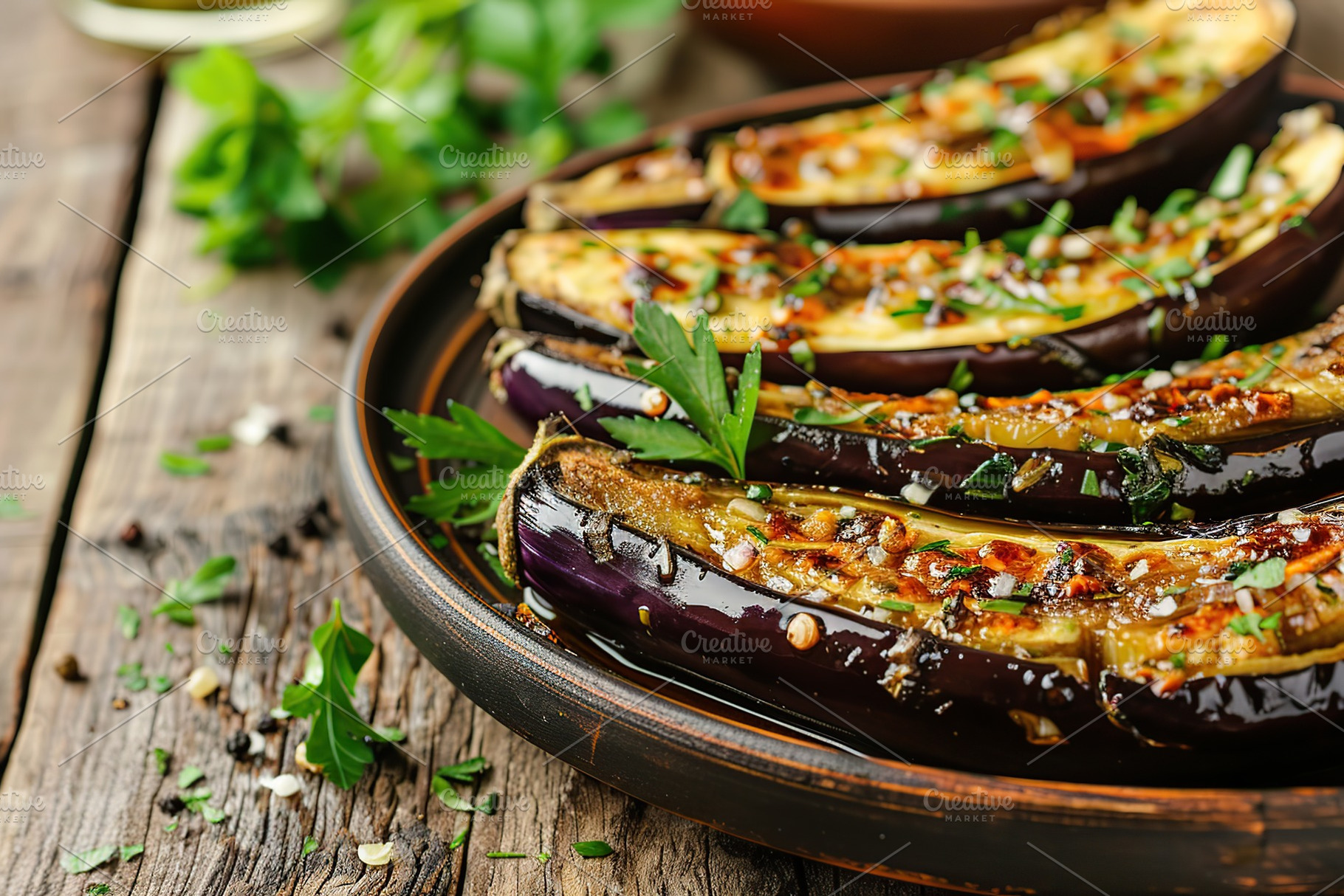 Baked eggplants in plate on wooden table, a Food & Drink Photo by AlyaAnd