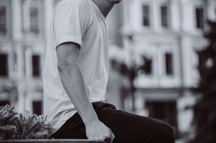 Guy sitting on the city street, look, a Person Photo by Tekso