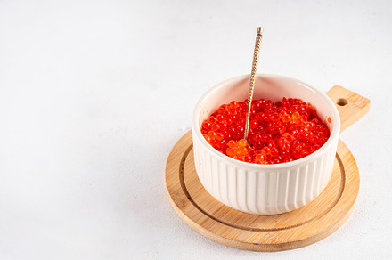 Artificial red caviar in a ceramic bowl, made from seaweed algae, a Food & Drink Photo by Rimma