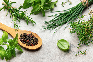Fresh herbs and peppercorns resting on kitchen table, a Food & Drink Photo by Olena Rudo