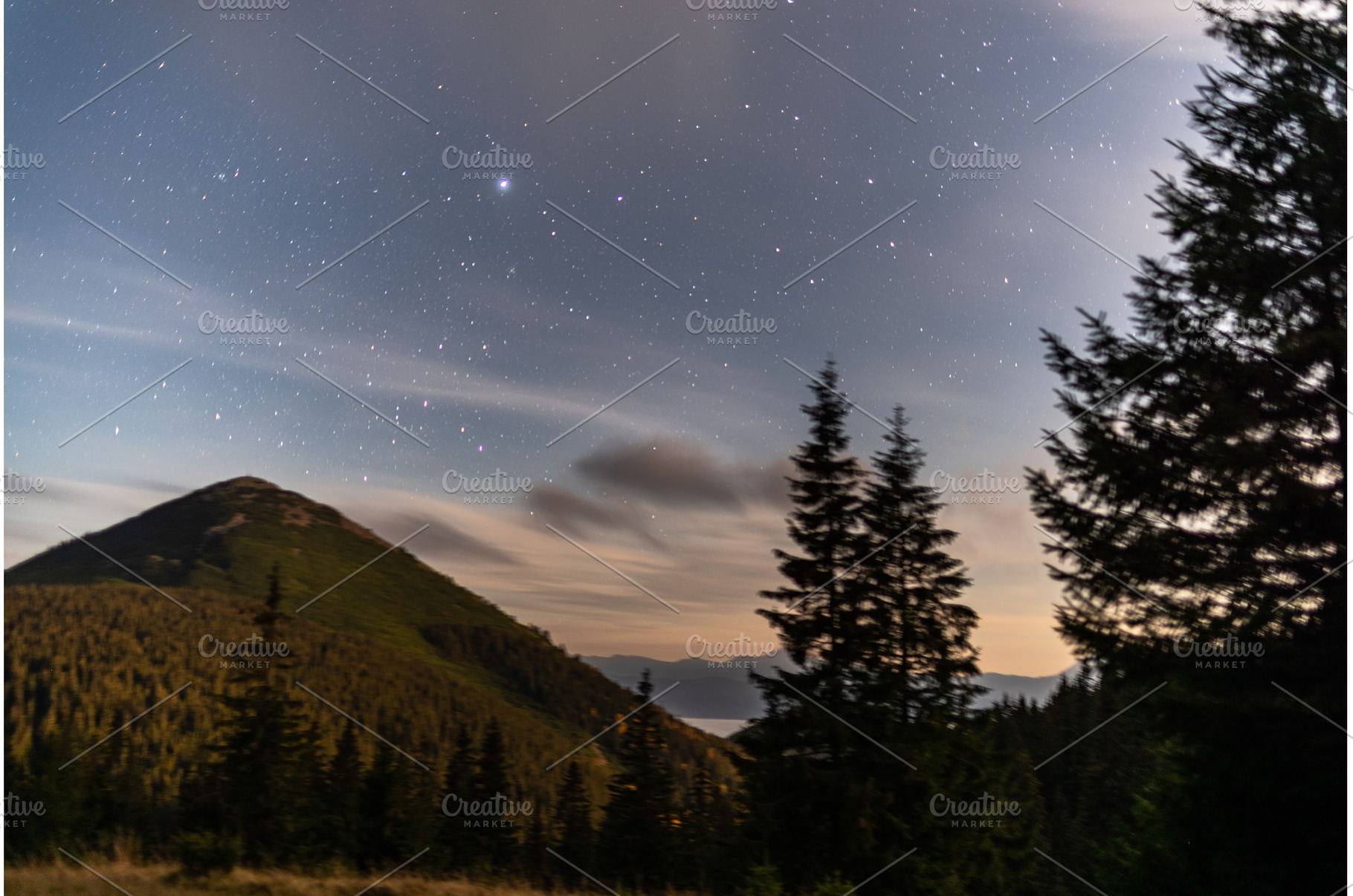 Starry night over mountain peak with, a Nature Photo by Stockphoto by vzwer