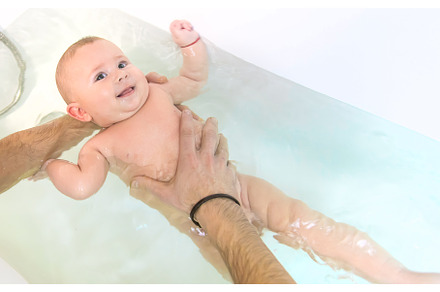 The father bathes the little baby, a Person Photo by yanadjana