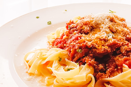 Pasta with bolognese sauce and parmesan cheese, homemade food an, a Food & Drink Photo by Anneleven