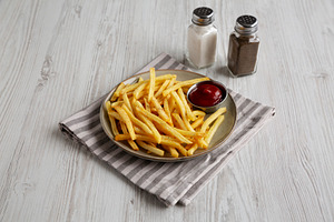 Homemade French Fries and Ketchup on a Plate, side view., a Food & Drink Photo by LiudmylaChuhunova