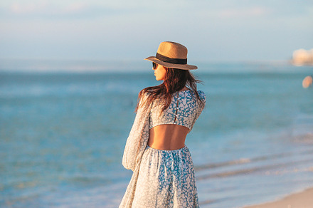 Young happy woman on the beach enjoy her summer vacation. Beautiful woman in ha, a Person Photo by travnikovstudio