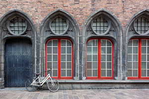 Lonely bicycle against old building, an Architecture Photo by BOOCYS