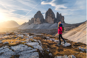 Girl with backpack on the mountain, a Nature Photo by den-belitsky