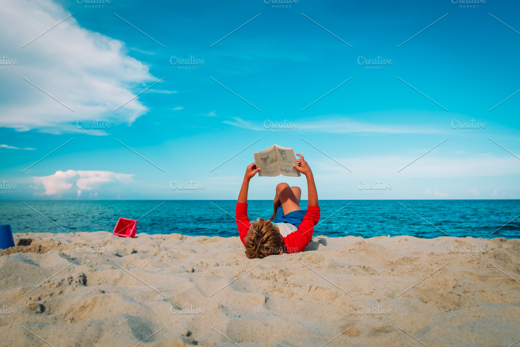 child reading on beach, a Person Photo by Nadezhda_Prokudina