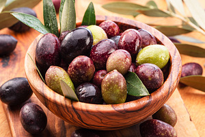 Fresh olives in wooden bowl, a Food & Drink Photo by Volff